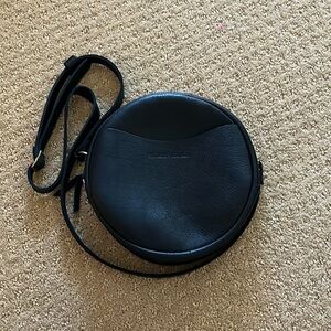 Portland Leather black circle crossbody bag.